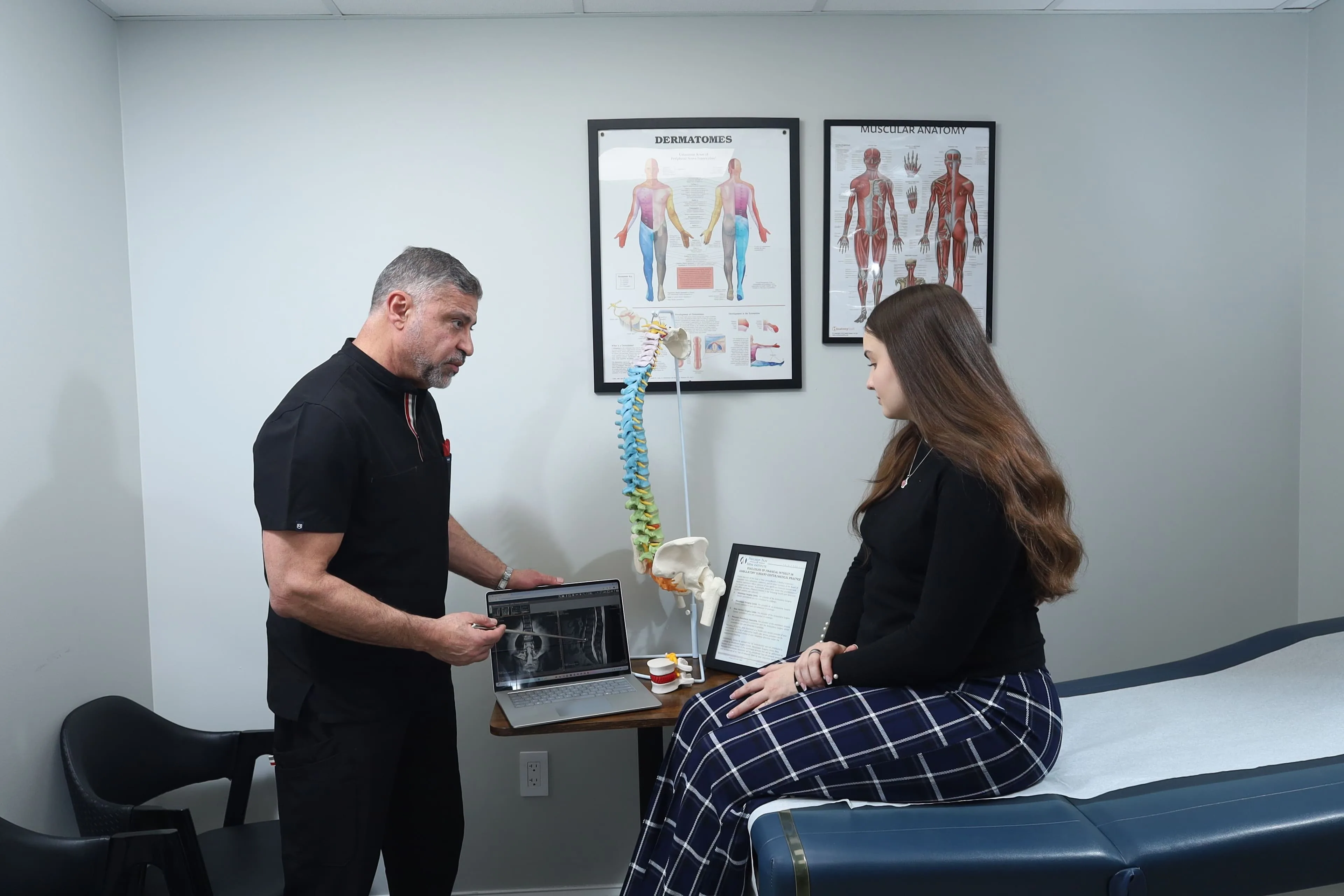 Dr. Elkholy showing patient imaging or treatment